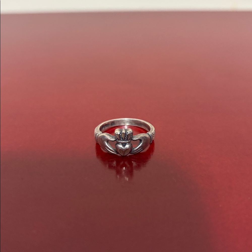 Claddagh style silver Hand holding heart ring crown hands